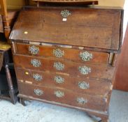 An antique oak bureau with good brass furniture (distressed)