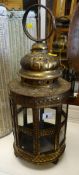 An antique brass & glass swinging lantern