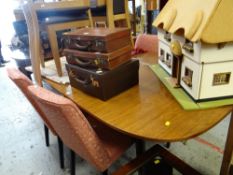A mid-century oval extending G-Plan dining table together with four pink upholstered dining chairs &