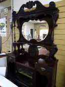 Edwardian mirror backed display sideboard, multi-shelved and mirrored with profuse carved detail
