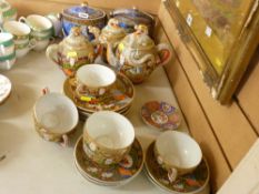Japanese Satsuma teaset, the cups with Geisha girl bases and two painted biscuit jars and covers
