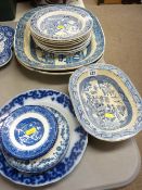 Quantity of Willow pattern blue and white dinnerware including two meat platters etc