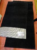 Two retro shaggy plain black rugs