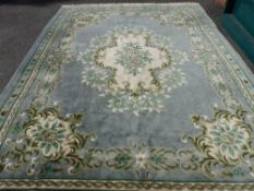Large Chinese washed woollen rug with floral design and tasselled ends, 385 x 274 cms