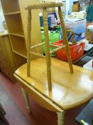 Light wood breakfast table with drop leaf and a wooden stool