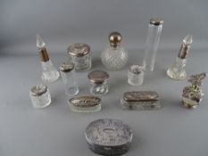 Collection of dressing table pots and bottles, most having silver lids