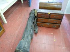 Vintage bag of golf clubs, a cased manual Singer sewing machine and four drawer wooden cabinet