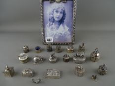 Modern cast photograph frame with a collection of EP and white metal decorative pill boxes