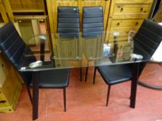 Ultra modern glass topped dining table and four black leather effect dining chairs