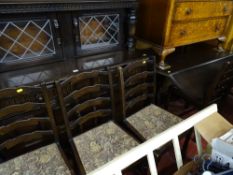 Dark wood Priory style drop leaf dining table with four ladderback chairs and a glazed Priory