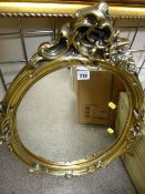 Gilt framed floral decorated oval wall mirror