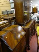 Walnut bureau with three drawers and ball and claw supports and a polished two door glazed front