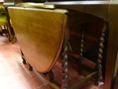 Oval oak drop leaf dining table with barley twist supports