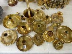 Large quantity of brass chambersticks, brass pestle and mortar etc