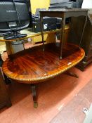 Large oval reproduction low coffee table with twin pedestal supports on brass claw feet and one from