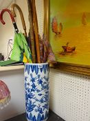 Blue and white porcelain stickstand with quantity of sticks and umbrellas etc