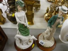 Pair of Continental figurines on wooden plaques