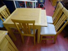 Good modern square topped draw leaf dining table with four matching chairs