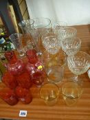 Pair of cranberry glass jugs, tumblers and other glassware including measures etc