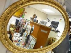 Fine gilt framed oval wall mirror, 89 cms wide