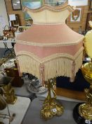 Converted elaborately decorated brass table lamp with shade