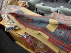 Two crewel work rugs together with another tribal-style rug