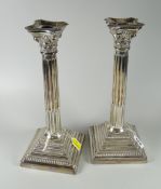 A pair of hallmarked London 1967 tall Corinthian candlesticks