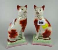A pair of Staffordshire pottery seated cats