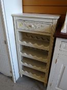 A painted French-style wine rack with drawer