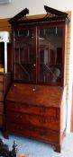 An antique mahogany bureau bookcase
