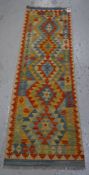 A vegetable dyed woollen Choli Kilim runner, 192 x 62cms