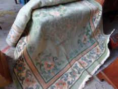 A Chinese washed floral green ground carpet
