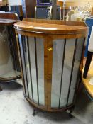 A half-moon single door vintage china cabinet