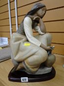 Lladro figurine on wooden plinth of a kneeling female with water jug