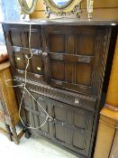 A linen fold cocktail cabinet