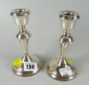 A pair of hallmarked silver short candlesticks