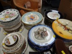 A large collection of decorative plates including Limoges cabinet plates, Royal Doulton,