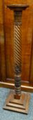 A carved barley-twist torchere