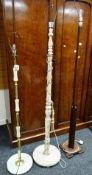 A vintage wooden standard lamp, a painted carved standard lamp & another