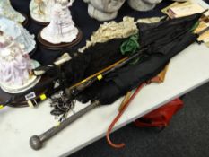 Parcel of parasols including a believed Indian silver handled example, a naturalistic bark effect