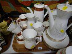 An Elizabethan burgundy patterned coffee set together with another similar German coffee set