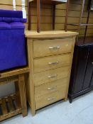 A modern lightwood five-drawer chest