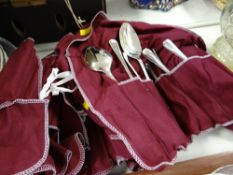 A parcel of loose cutlery in covers