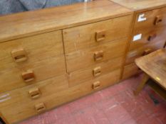 Pair of light wood seven drawer chests with wooden cup handles