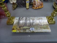 Flaxman tile teapot stand and a pair of brass candlesticks