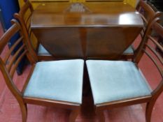 Mahogany inlaid single pedestal dining table with four chairs