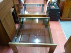 Pair of stylish teak coffee tables with smoky glass tops