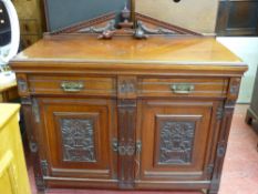 Polished wood railback sideboard with two drawers over two base cupboards having floral carvings
