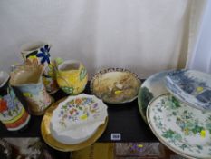 Quantity of decorative wall plates, large pottery plaque and four colourful vintage style jugs