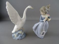 Two Nao figurines of a young girl with flowers and a goose taking flight